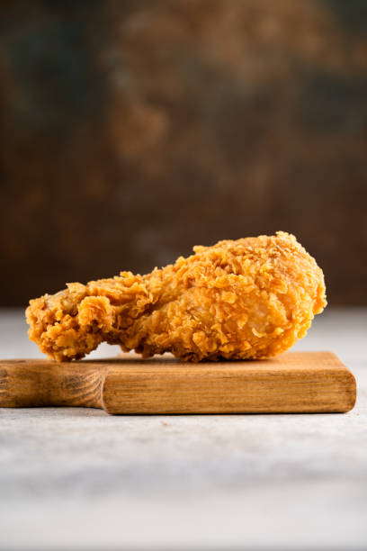 istock Delicious and crispy fried chicken legs on vintage  background 2187737844