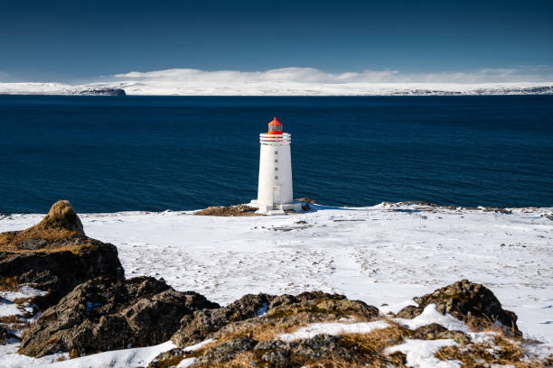 istock Lighthouse in Snowy Icelandic Landscape 2187738035