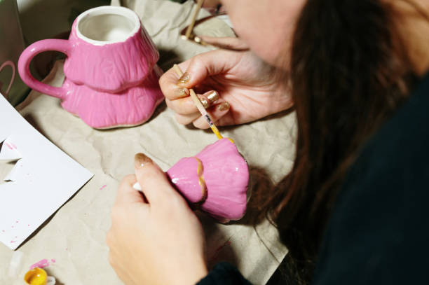 istock Painting a Christmas tree mug 2187739839