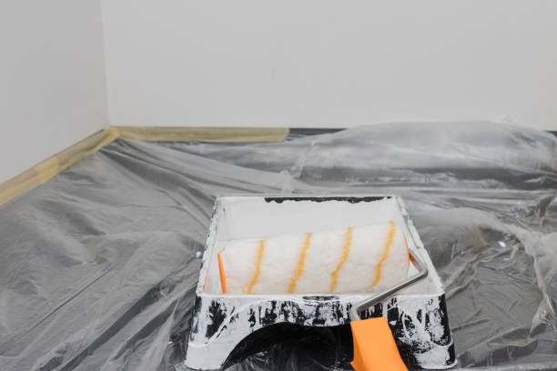 istock Paint roller is sitting on a tray with a white paint roller 2187739871