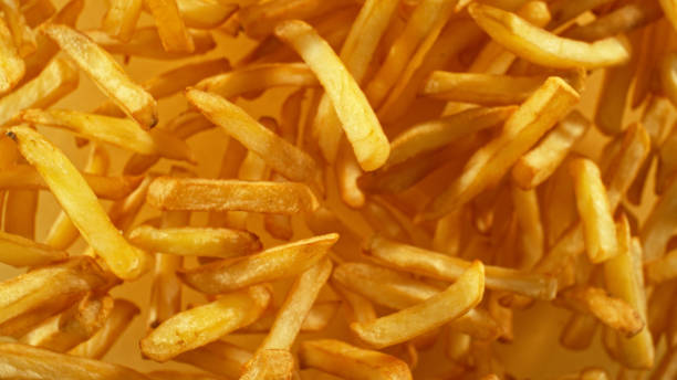istock French fries - fried potatoes flying. 2187742558