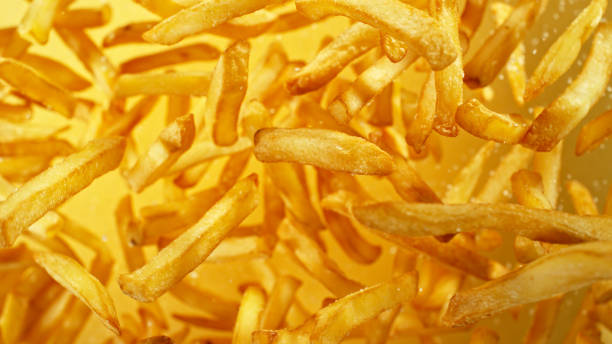 istock French fries - fried potatoes flying. 2187742566