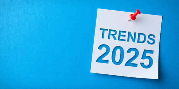 istock Trends 2025 Word in White Sticky Note on Blue Cardboard Background 2187742787