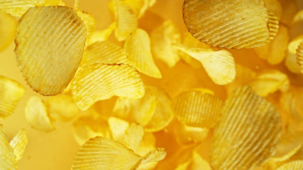 istock Potatoes chips flying up in the air. 2187743799