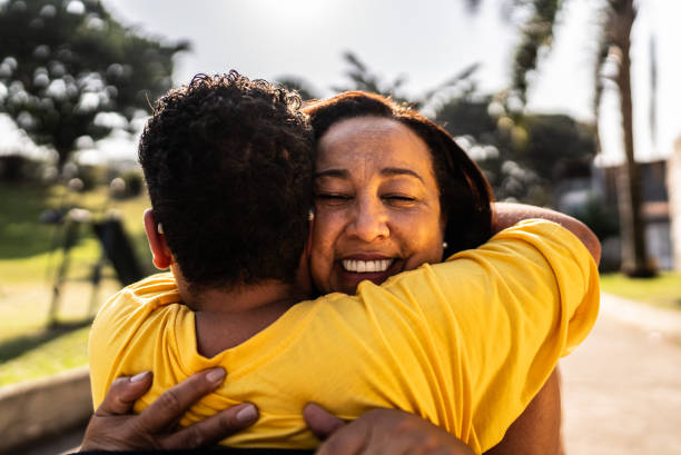 istock Mother and son embracing in a public park 2187744514