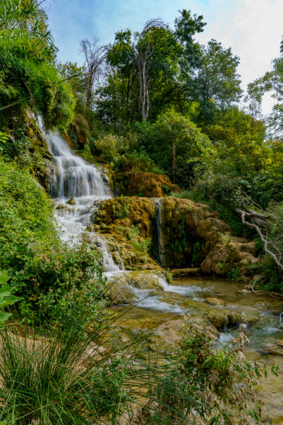 istock Beautiful view of the waterfalls covered in a dense forest 2187745126