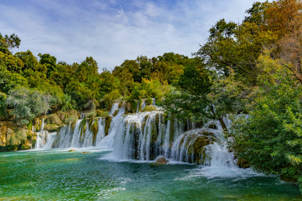 istock Beautiful view of the waterfalls covered in a dense forest 2187745211