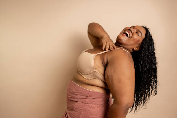 istock Happy woman in beige background at studio shot 2187747801