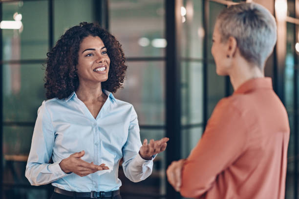 istock Two beautiful businesswomen talking 2187754723