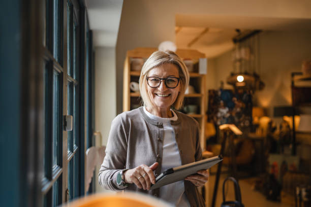 istock mature woman entrepreneur work on digital tablet at rustic shop 2187756814