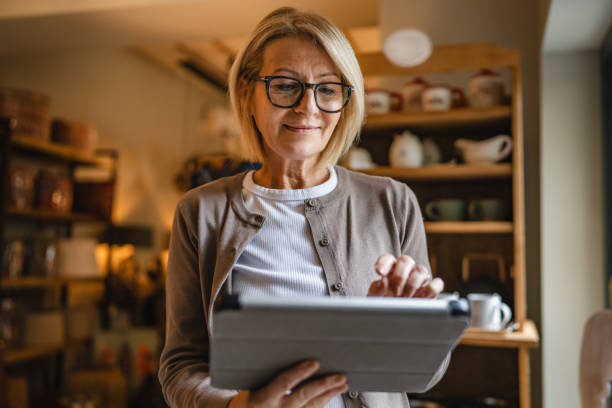 istock mature woman entrepreneur work on digital tablet at rustic shop 2187756934