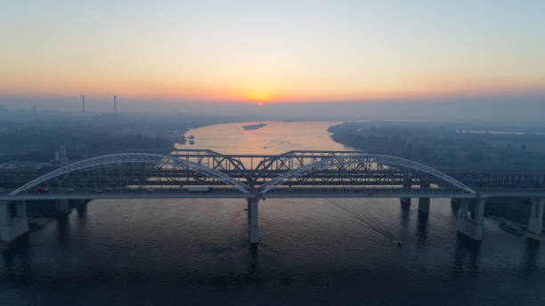 istock Bridge spans a river with a beautiful sunset in the background 2187758991