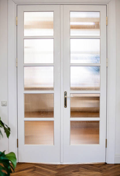 istock White Double Doors with Ribbed Glass Panels in Modern Interior 2187759079
