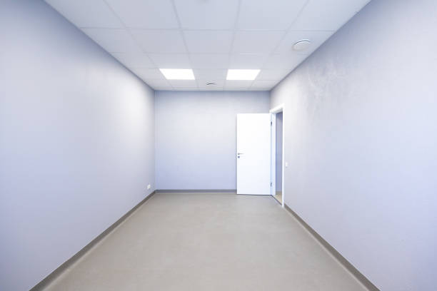 istock Minimalist Empty Room with Light Gray Walls and Recessed Lighting 2187759110