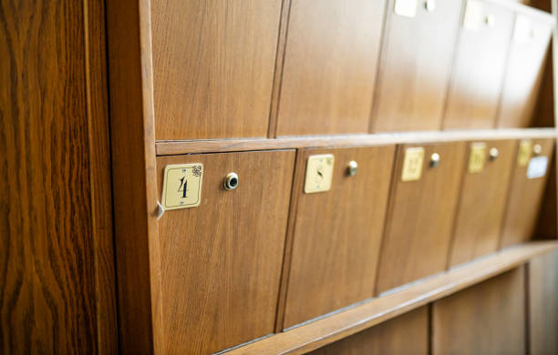 istock Row of Wooden Mailboxes with Numbered Metal Plaques 2187759131
