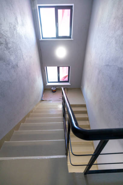 istock Modern Stairwell with Beige Steps and Black Metal Railing 2187759140