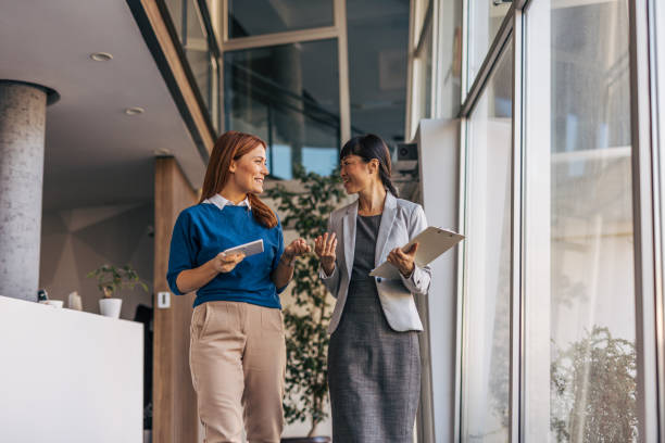 istock Female employees walking down the company corridor 2187760674