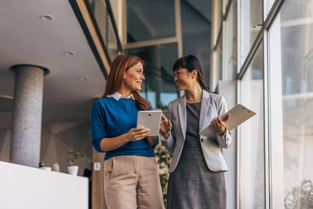 istock Business partners walking together and talking 2187761275