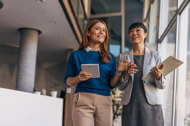 istock Female employees walking down the company corridor 2187761313