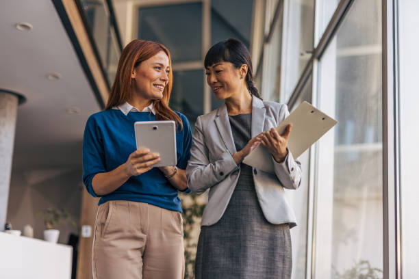 istock Business partners walking together and talking 2187761337