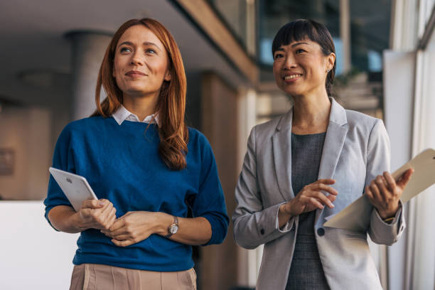 istock Two professional women smiling in a modern office setting 2187761436