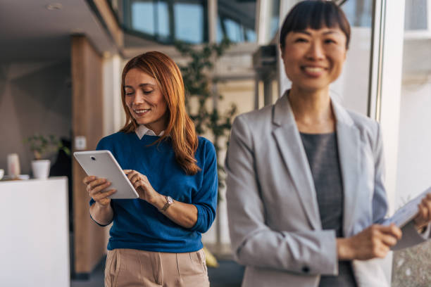 istock Professional women exiting an office meeting discussion 2187761612