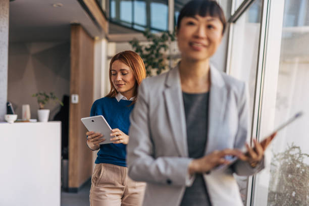 istock Professional women exiting an office meeting discussion 2187761655