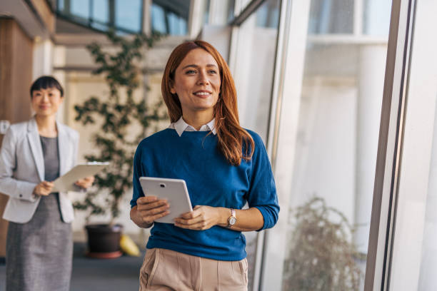 istock Professional women exiting an office meeting discussion 2187761709
