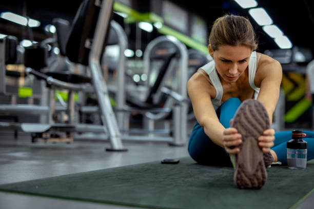 istock Pre-Workout Stretch: Woman Warming Up Her Muscles in the Gym 2187761881