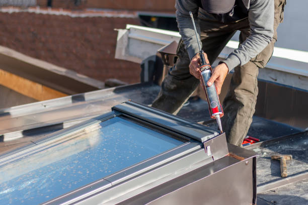 istock Construction worker using silicone sealant adhesive to fix a metal sheet on the skylight window. 2187763372