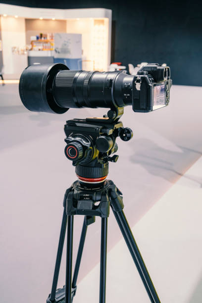 digital mirrorless camera with telephoto lens on tripod