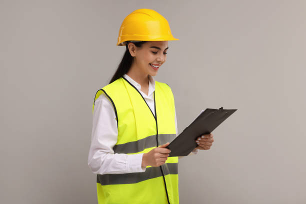 istock Engineer in hard hat holding clipboard on grey background 2187765056