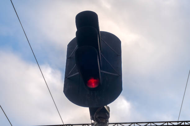 istock Red light for trains. Traffic light on sky background 2187769019