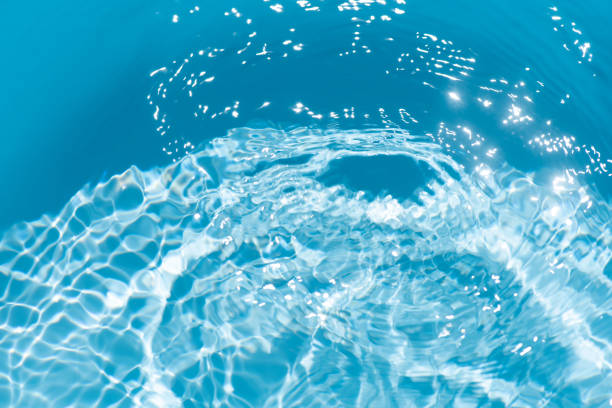 istock Blue water with ripples on the surface. Defocus blurred transparent blue colored clear calm water surface texture with splashes and bubbles. Water waves with shining pattern texture background. 2187769108