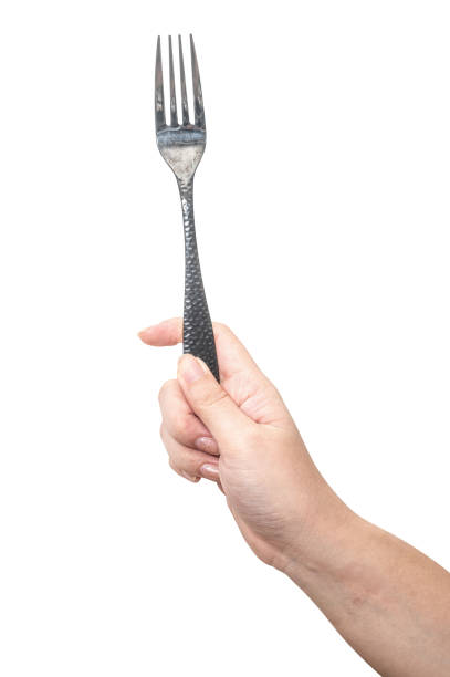 istock Female hand holding a black steel fork isolated on white background. 2187769204