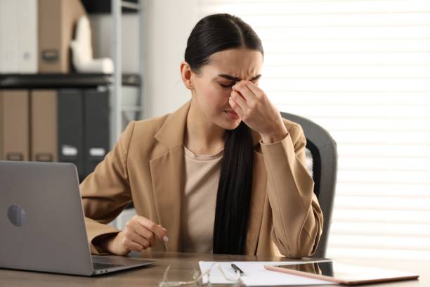 istock Woman suffering from headache at workplace in office 2187774071