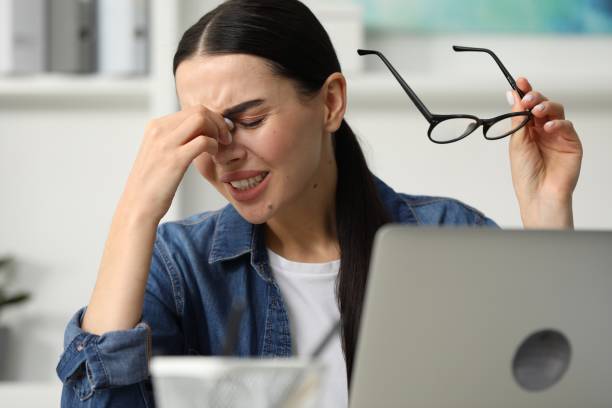 istock Woman suffering from headache at workplace in office 2187774113