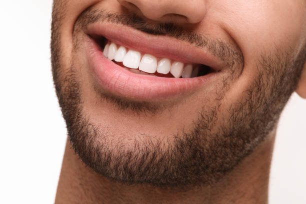 istock Smiling man with healthy clean teeth on white background, closeup 2187774196