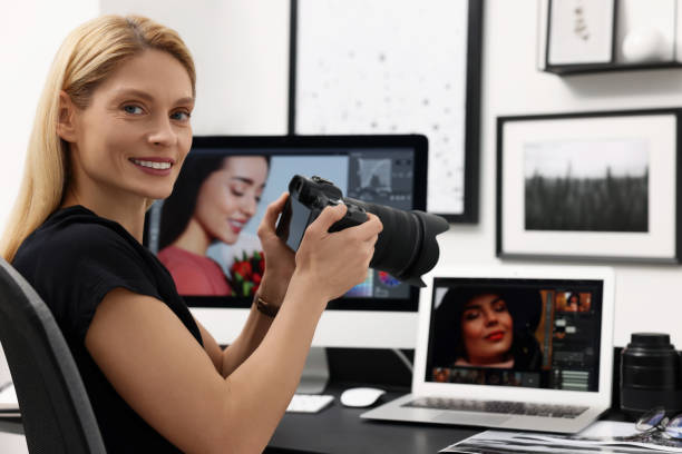 istock Professional photographer with digital camera at table in office 2187775028