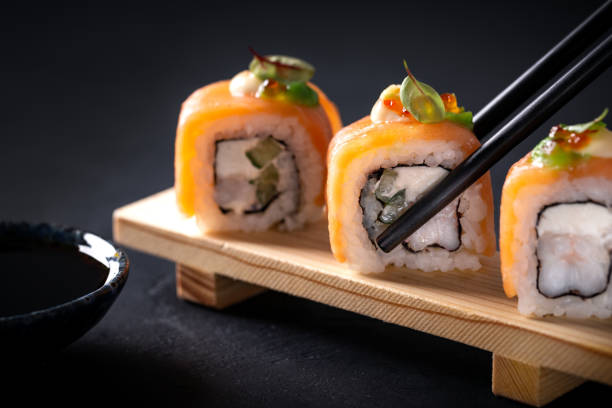 istock Japanese cuisine. Sushi rolls on a black platter 2187779662