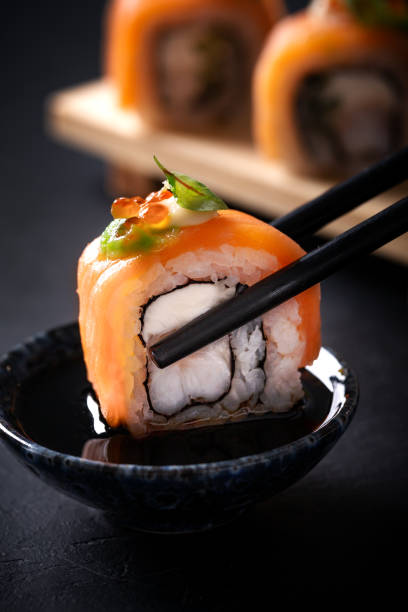 istock Japanese cuisine. Sushi rolls on a black platter 2187779686