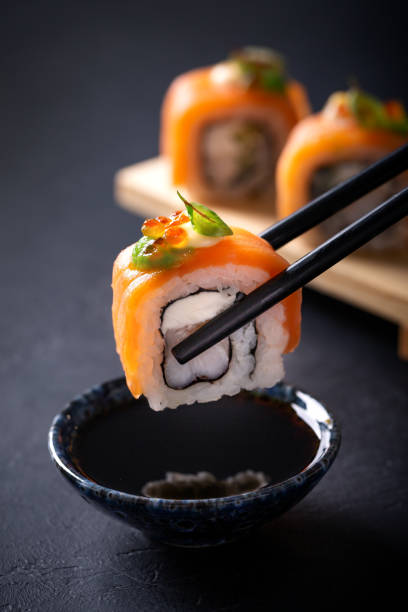 istock Japanese cuisine. Sushi rolls on a black platter 2187779689