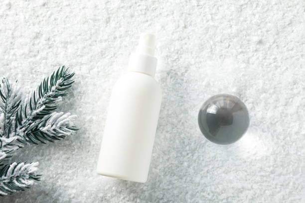 istock Cosmetic bottle and fir branch on light background, top view 2187780330