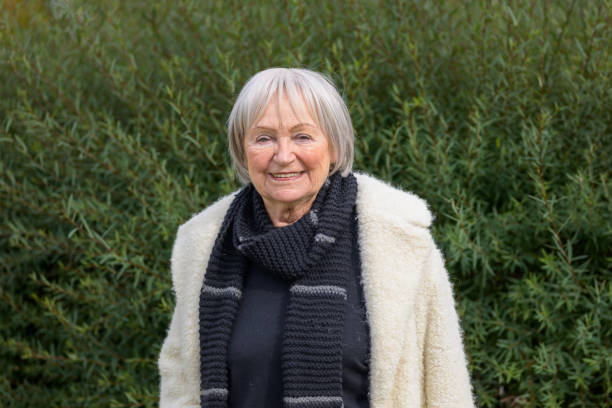 istock Elderly Woman Smiling in a Peaceful Outdoor Setting 2187783657