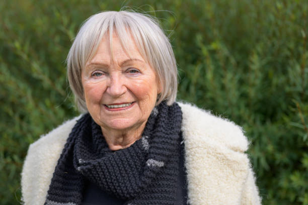 istock Elderly Woman with a Kind Smile in a Green Setting 2187783658