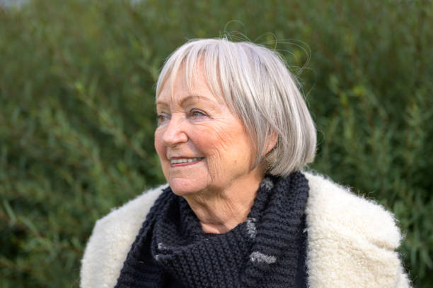 istock Elderly Woman Smiling Peacefully in Nature 2187783684