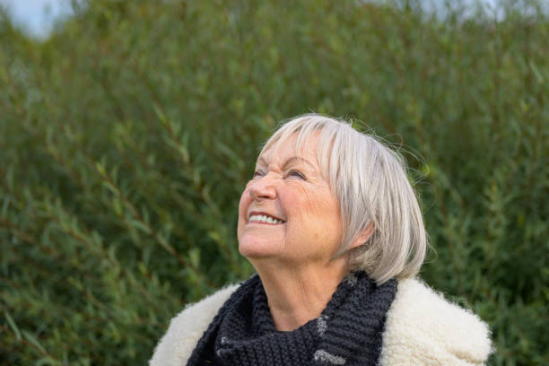istock Elderly Woman Smiling Upwards in a Natural Setting 2187783710