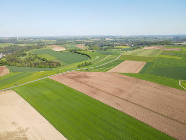 istock View from above of a landscape with farm fields, a road and trees in spring 2187784155