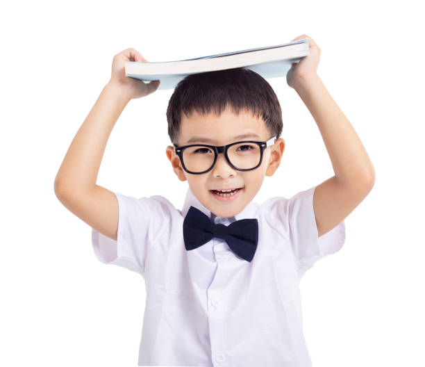 istock Little schoolboy with book  isolated on white background 2187784335