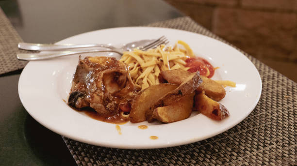 istock Fettucini with beef cooked with curry ingredients. Served on a white plate on a wooden table. 2187785574